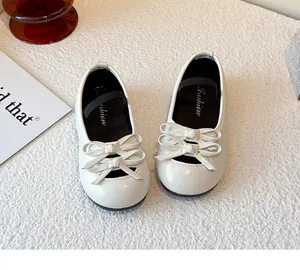 Detailed macro view of decorative double bow ties on white girls' toddler shoes