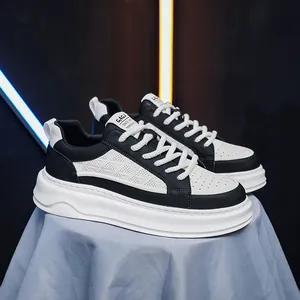 Close-up of breathable black and white leather sneakers with thick platform soles.