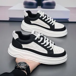 Detail of black and white platform sneakers with leather texture and white laces.