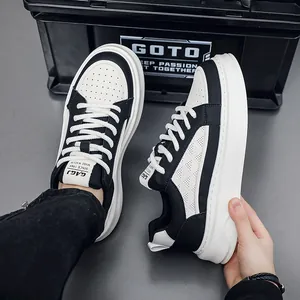 Close-up of black and white breathable leather platform sneakers with textured details.