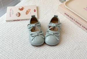 Detailed view of girls' mint green patent leather Mary Jane shoes with double bows
