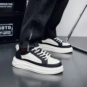 Close-up of men's stylish breathable black and white leather platform sneakers on-foot.