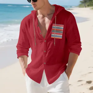 Detail of red linen hooded shirt with a bohemian striped pocket on a sunny beach