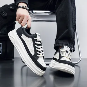 Close-up view of men's black and white leather platform sneakers with perforated texture