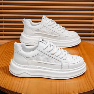 Detail view of men's white platform leather sneakers featuring triangle perforated patterns