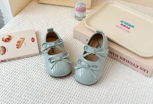 Close-up detail of mint green Mary Jane shoes for girls featuring elegant double bow accents