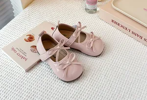 Elegant pink Mary Jane shoes for girls with decorative double bow and cross straps