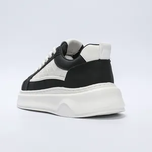 Detailed rear view showing white platform sole on men's black and white leather sneakers