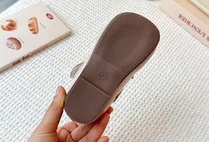 Bottom detail of toddler girl Mary Jane shoes with non-slip brown soft rubber sole.