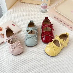 Stylish children's patent leather Mary Jane shoes with double bows in four vibrant colors.