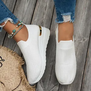 Elegant white fly-knit wedge sneakers for women featuring a stylish gold metallic heel trim