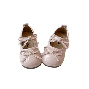 Elegant pink patent leather Mary Jane shoes for girls featuring cute double bow accents