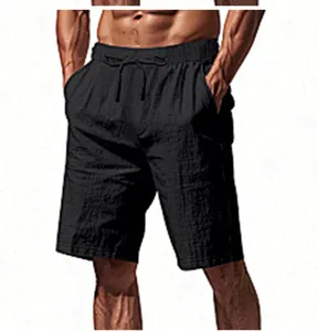 Close-up view showing the fabric texture and drawstring waist of black linen shorts