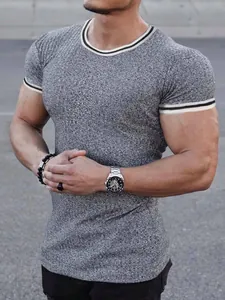 Macro view of grey athletic fit t-shirt featuring striped trim and textured fabric