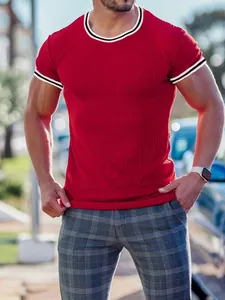 Close-up of red ribbed men's slim fit T-shirt with contrast striped collar and cuffs detail