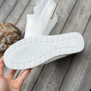 Close-up of white platform sole on breathable flying woven mesh sneakers.