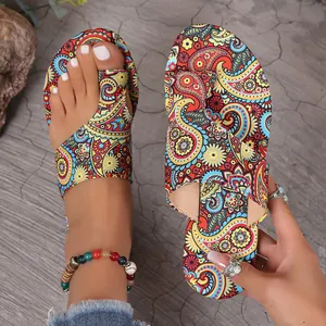 Detailed view of vibrant bohemian paisley printed flat sandals with toe-loop design