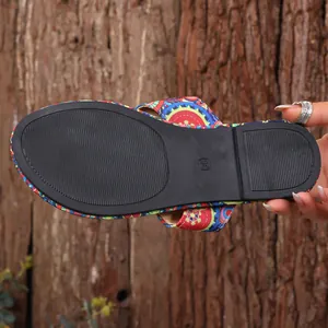 Close-up of anti-slip black rubber sole on Bohemian ethnic print flat slipper