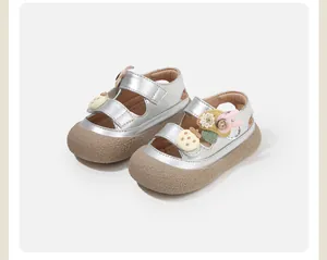 Detailed view of silver closed-toe baby sandals with cute floral and bunny decorations