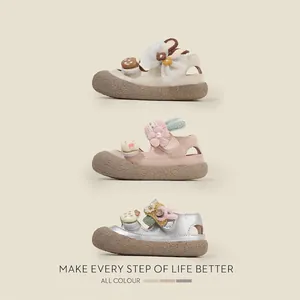 Toddler girls' closed-toe sandals in pink, cream, and silver with cute 3D decorations.