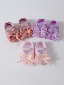 Three pairs of cute baby girl lace princess shoes in pink, peach, and purple colors.