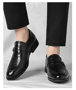 Close-up of black crocodile embossed men's business casual slip-on loafers with buckle
