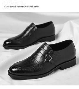 Detail view of black crocodile pattern men's loafers with metallic buckle accent