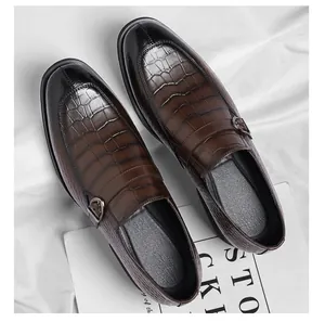 Detailed view of men's dark brown crocodile embossed leather loafers with buckle