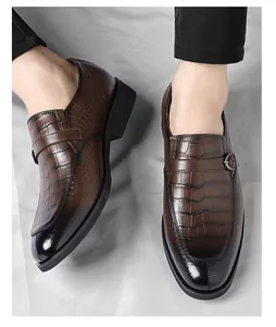 Close-up view of brown crocodile pattern men's business casual loafers with side buckle