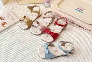 Detailed view of girls' floral flat sandals with bow knots in four colors