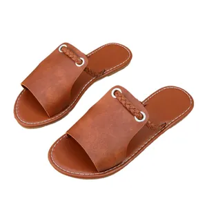 Elegant casual women's flat brown slides featuring woven strap detail and white stitching