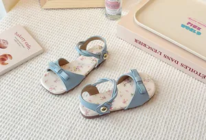 Elegant light blue children's flat sandals featuring a floral insole and a cute bow