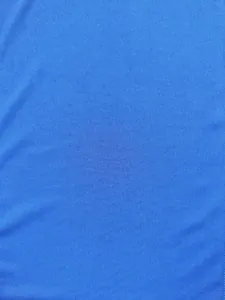 Macro shot of bright blue vertical ribbed knitted fabric texture for men's fitness tank top.