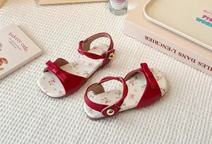 Detail view of red girls sandals with bow accent and floral printed insole decoration
