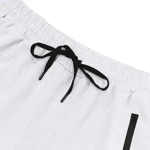 Close-up detail of elastic waistband and black drawstring on white athletic shorts