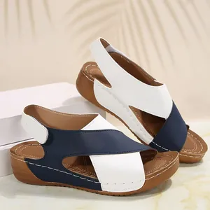 Detailed side view of navy blue and white color-block wedge platform sandals for women