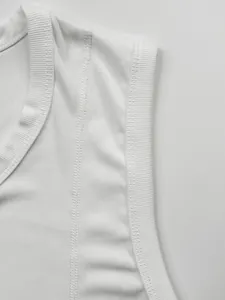 Detailed macro shot of white ribbed knit fabric and reinforced stitching on men's muscle tank top