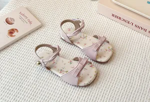 Detailed macro view of children's floral flat sandals with elegant bow decoration