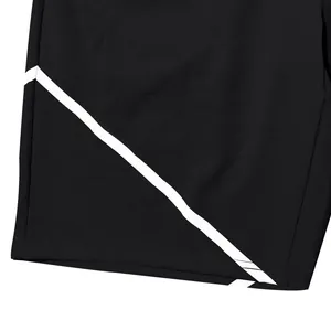 Close-up detail of American style black athletic shorts with white diagonal stripe