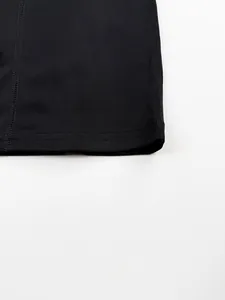 Close-up of ribbed knit fabric texture and seam on black fitness tank top