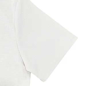 Close-up of white waffle knit fabric texture on men's short sleeve Polo shirt.