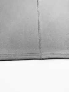 Macro detail of grey ribbed knit fabric and double stitching on men's sports vest