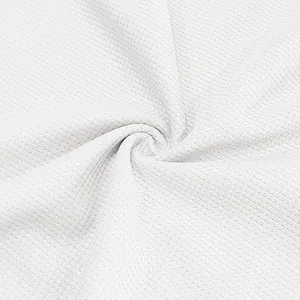 High resolution macro detail of white waffle knit fabric texture for men's polo shirt