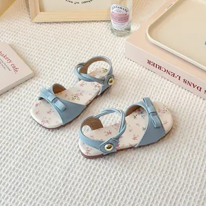 Light blue floral girl's sandals with cute bow detail and secure ankle straps