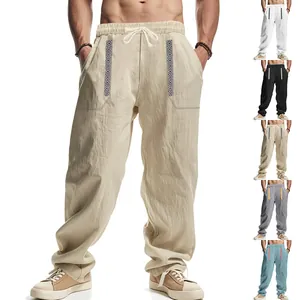 Men's loose linen-blend pants featuring bohemian ethnic patterns on front pockets