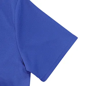 Close-up of blue waffle knit fabric detail on men's short sleeve polo shirt