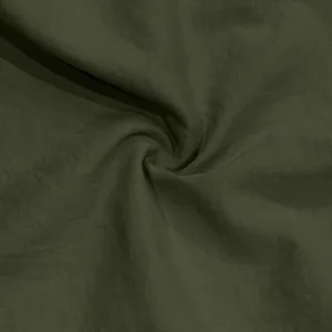 Close-up detail showing the soft olive green fabric texture of casual men's summer sports shorts