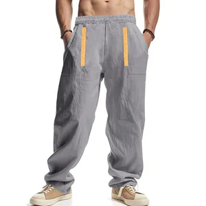 Detail view of men's breathable loose linen trousers with bohemian pattern on pockets
