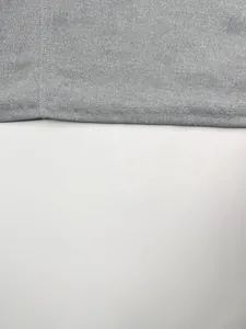 Macro detail of grey ribbed fabric and stitching on a men's fitness vest