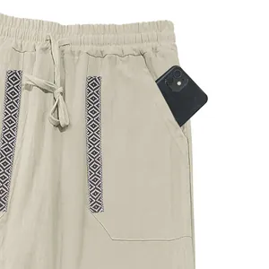Close-up of men's bohemian linen pants with functional side pocket and drawstring